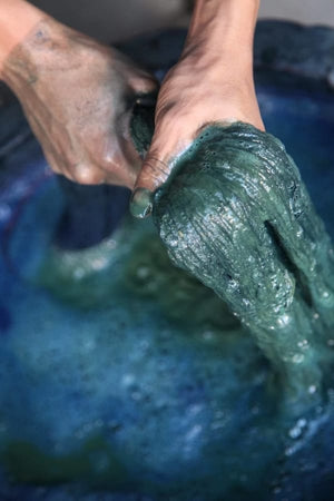 Dying sustainable cotton using natural indigo dye for Rare & Fair's handmade clothing range